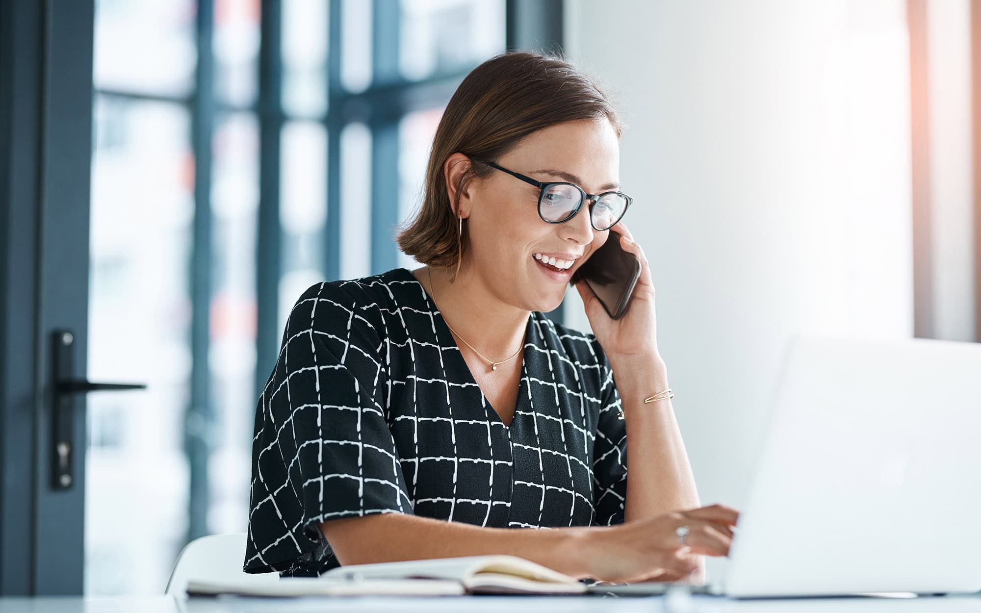 Happy, Woman And Phone Call In Office With Laptop For Work As Receptionist