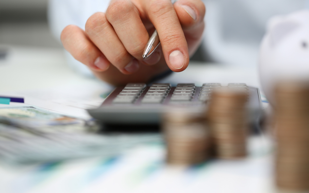 Male Hand Push Key Silver Calculator Is Lying On Desk Cash Dollar Plots In Home Office Setting