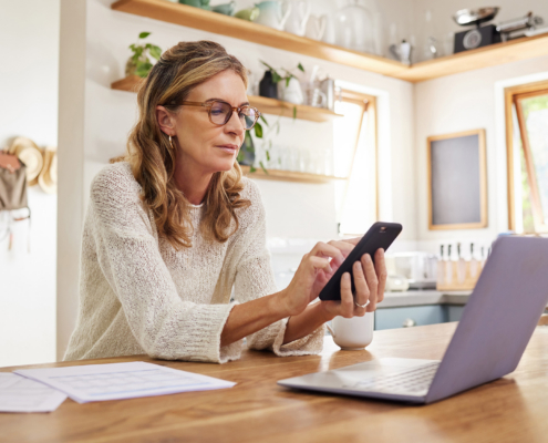Person Doing Taxes At Laptop
