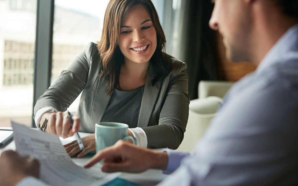 Workers Looking At Taxes On Paperwork