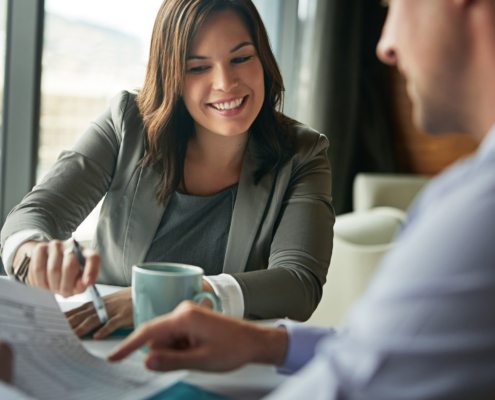 Workers Looking At Taxes On Paperwork