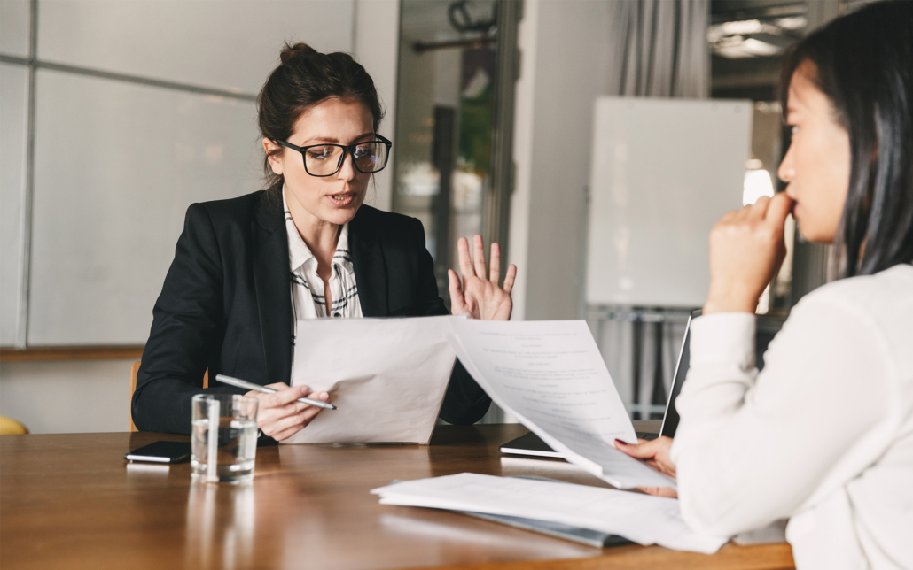 Image Of Strict Caucasian Businesswoman Holding Resume