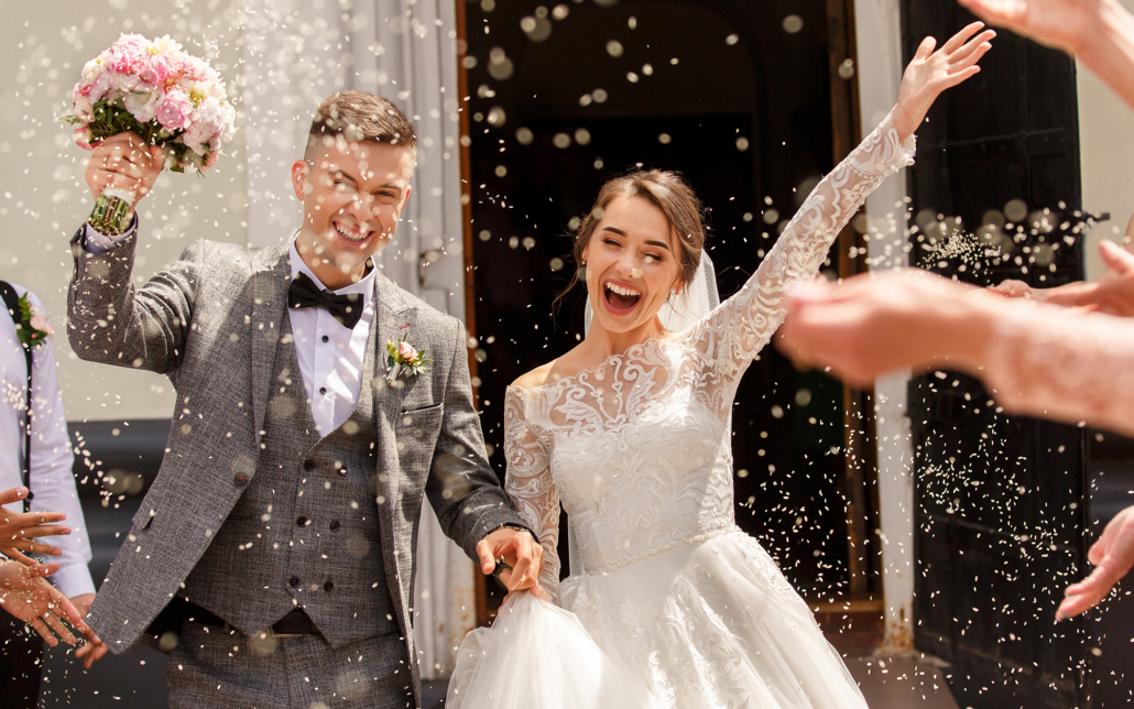 Married Couple Walking Through Flower Pedals Thrown In The Air